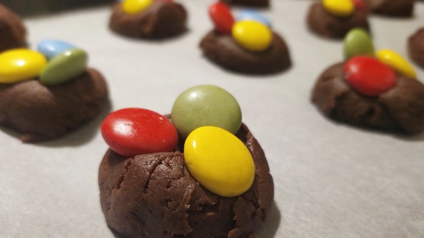 The candy cookies on a tray before getting in the oven